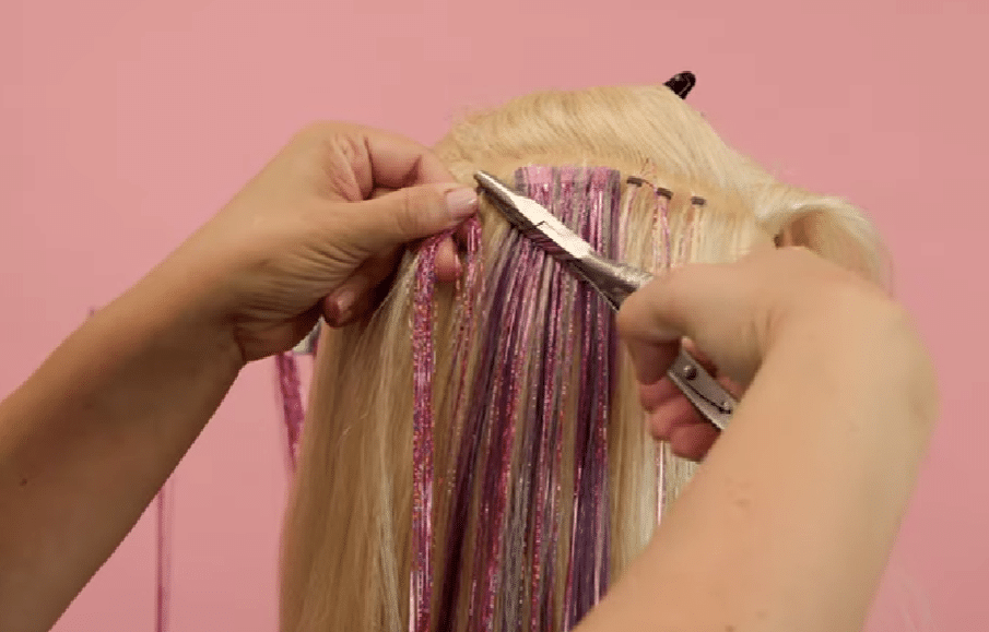 removing hair tinsel with plier